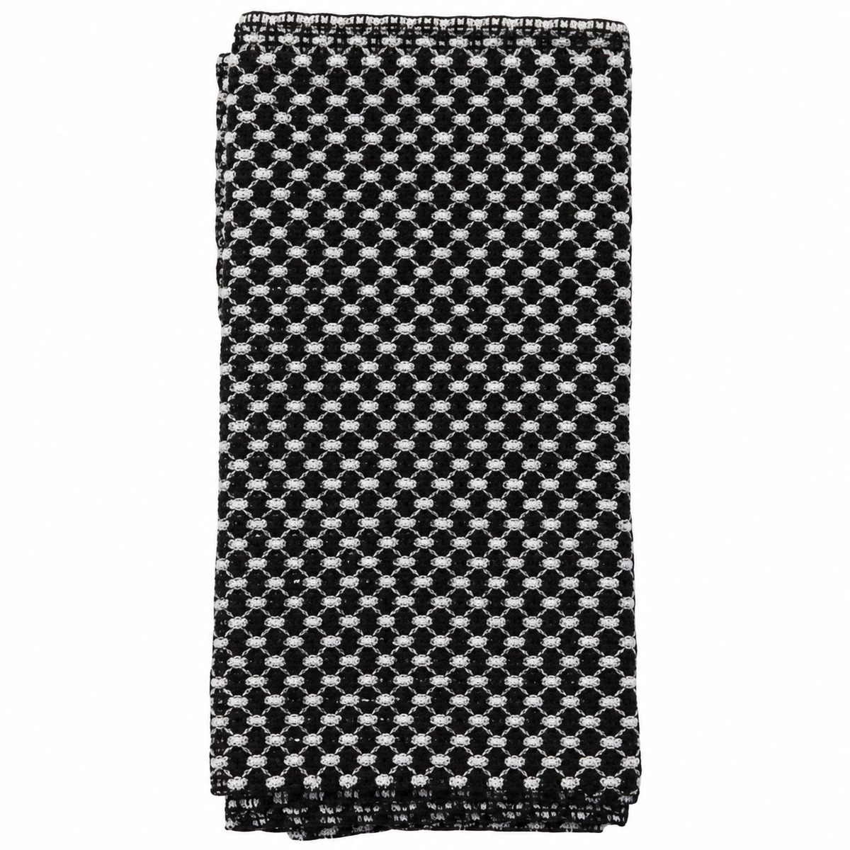 La Serviette 360 exfoliante de Jociia, noire avec motif tissé blanc, présentée pliée sur un fond blanc professionnel.